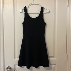 Black divided short dress. Open back. High rise neck. Size 4